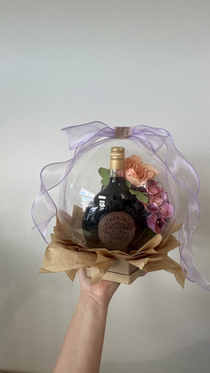 Wine bottle balloon gift with silk flowers and lavender ribbon